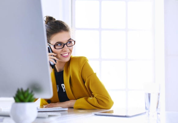 woman with yellow jacket talking on phone