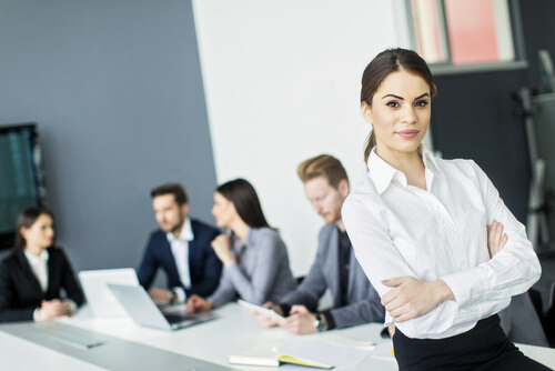 woman sitting on table with arms crossed