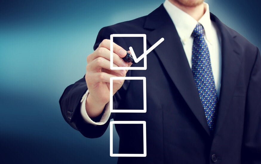 man in suit checking over boxes