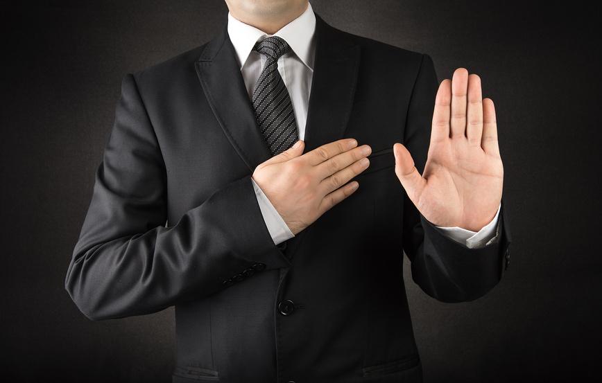 Men in suits taking oath