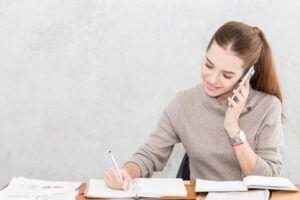 woman on the phone taking notes
